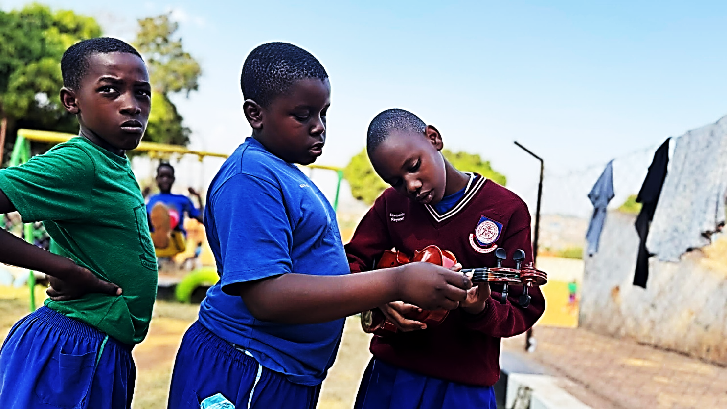 A student learning keyboard with a mentor
