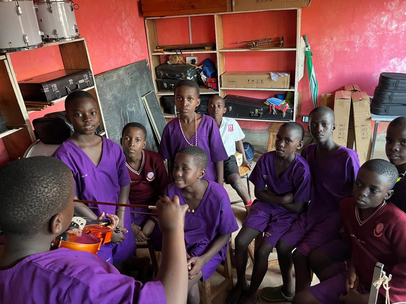 Youth mentor teaching violin to children